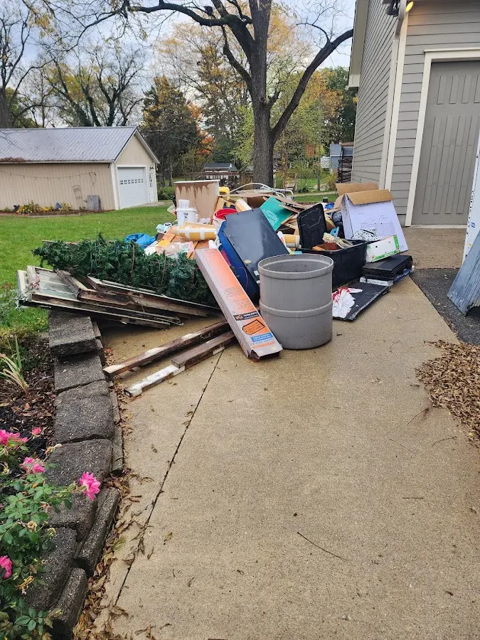 Dumpster being loaded with debris for Residential Dumpster Rental in Delafield